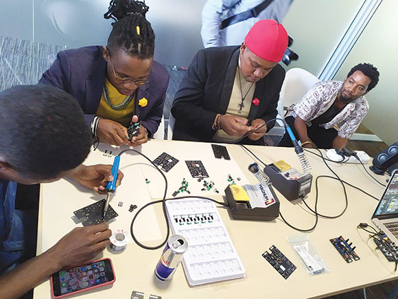 Students getting their hands on creating some tech at the event.